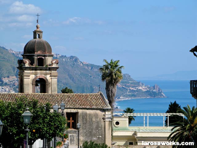 Taormina views are stunning with the azure Able Sea below and Mount Etna billowing behind